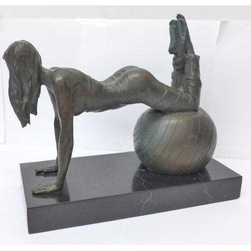 808 - A bronze figure of a girl exercising on a black onyx plinth