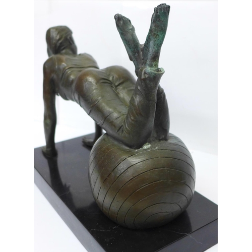 808 - A bronze figure of a girl exercising on a black onyx plinth