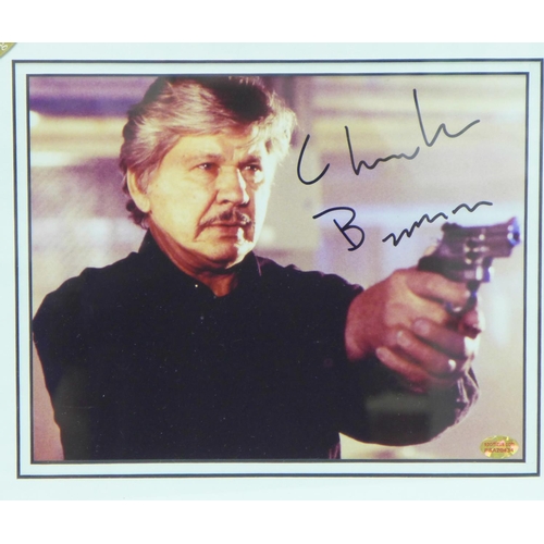 823 - A signed Charles Bronson mounted and framed photograph with a certificate of authenticity on reverse... 