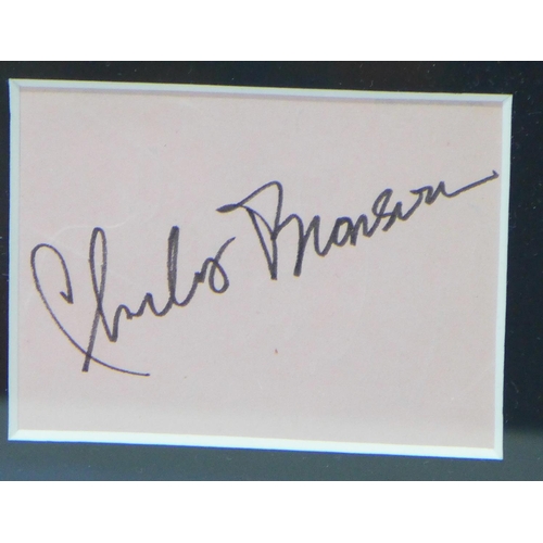 823 - A signed Charles Bronson mounted and framed photograph with a certificate of authenticity on reverse... 