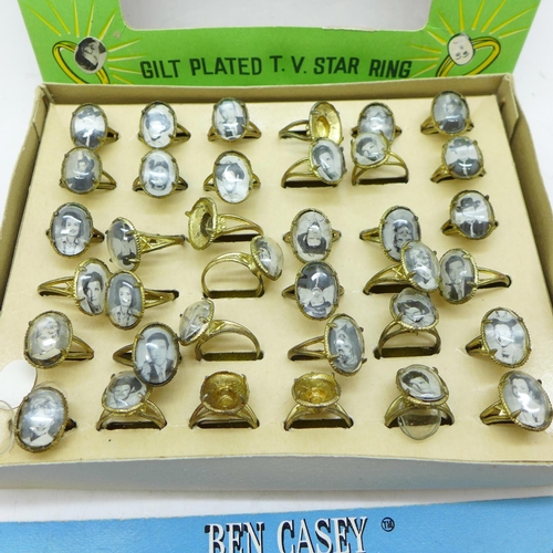 838 - American interest; box of TV star metal rings and a Ben Casey charm bracelet 1962