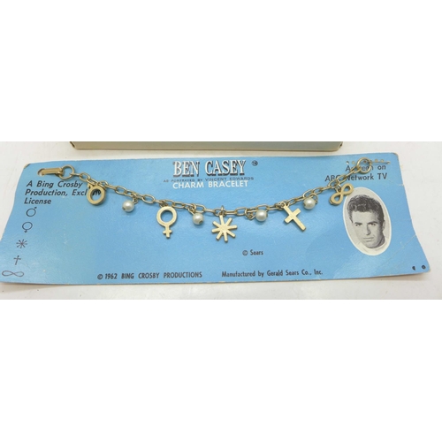 838 - American interest; box of TV star metal rings and a Ben Casey charm bracelet 1962