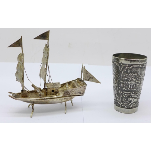 857 - A white metal bowl, marked 830, a shot and a small model boat