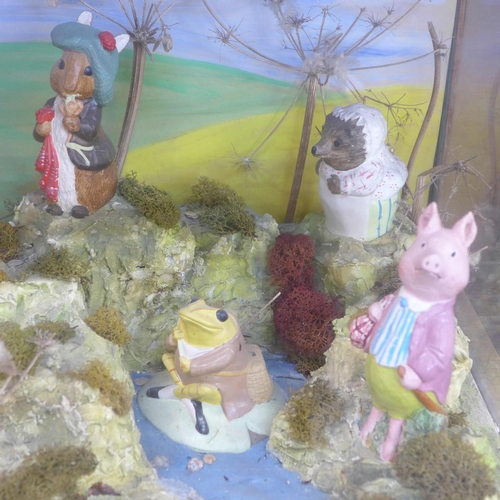 681 - A Beatrix Potter Peter Rabbit shop display diorama containing eight figures, in a glass display case... 