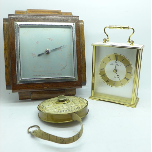 684 - A lawn tennis measuring tape, an oak barometer and a clock