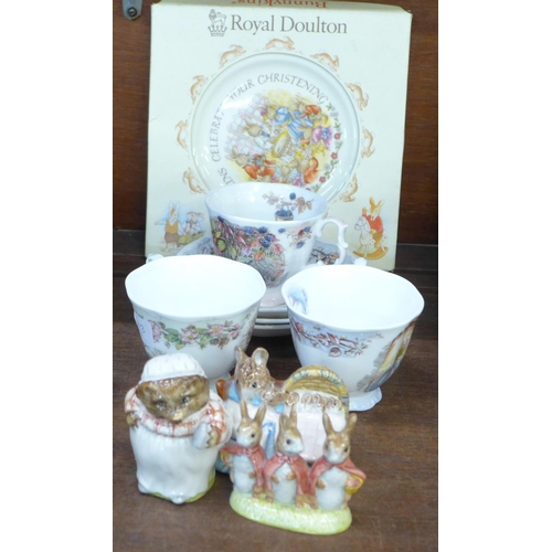 696 - Three Royal Albert Beatrix Potter figures, three Royal Doulton cups and saucers and a christening pl... 