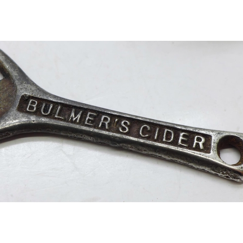 697 - A bottle opener, two other bottle openers including Bulmer's Cider, flatware, etc.