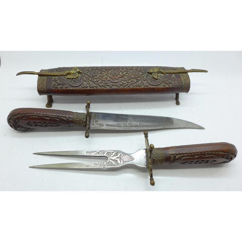 718 - A Puma knife with blade marked Solingen, one other knike and a set of carvers