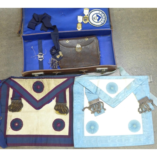 763 - A leather Masonic case with aprons, medals and pouch