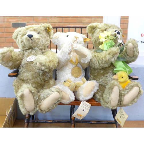 764 - Four Steiff Teddy bears, two with growlers and one small, on a wooden Windsor style seat, (four bear... 