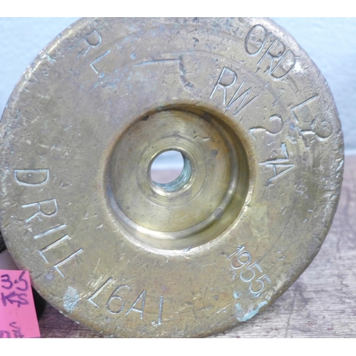 808 - A '25 pounder' military shell case marked 1955, one similar 30mm shell case, a brass drill round bas... 