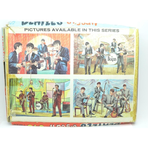 834 - A Beatles 1960's jigsaw and a small George Harrison flag