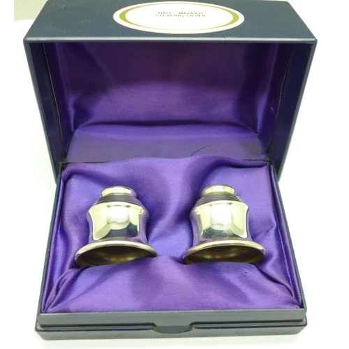 902 - A pair of silver candle caps in a fitted case