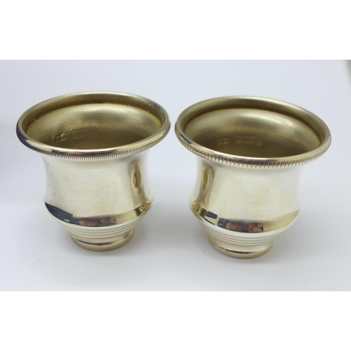 902 - A pair of silver candle caps in a fitted case