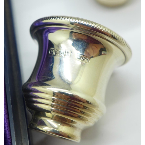 902 - A pair of silver candle caps in a fitted case