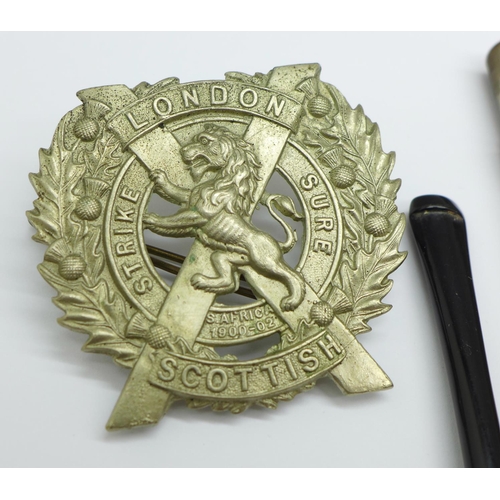 910 - A London Scottish Regiment badge, a silver half buckle, a gilt £5 coin, etc.