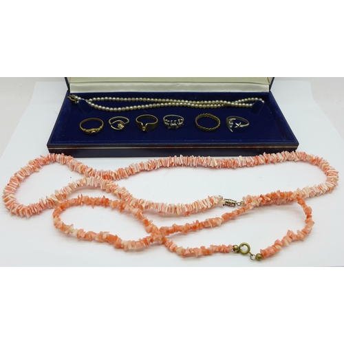 945 - A coral necklace, one other shell necklace, costume rings and a faux pearl necklace