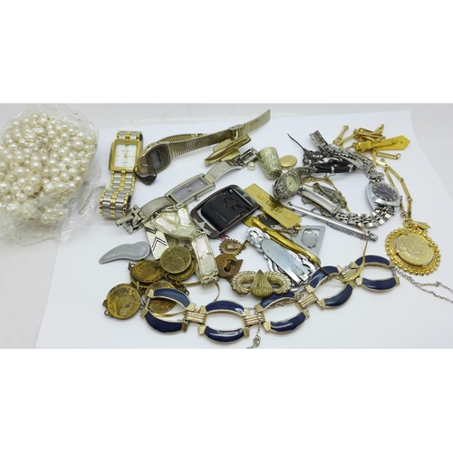 946 - A 9ct gold locket and chain, 2g, lady's wristwatches and other mixed jewellery, tie clips and a thim... 