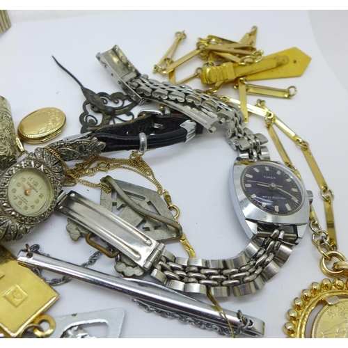 946 - A 9ct gold locket and chain, 2g, lady's wristwatches and other mixed jewellery, tie clips and a thim... 