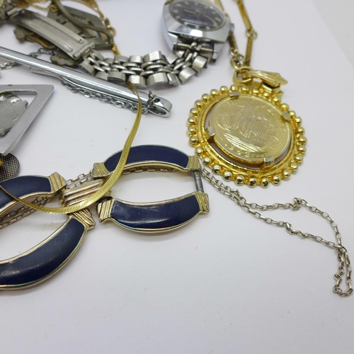 946 - A 9ct gold locket and chain, 2g, lady's wristwatches and other mixed jewellery, tie clips and a thim... 