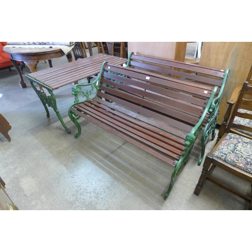 402 - A pair of cast iron garden benches and matching table