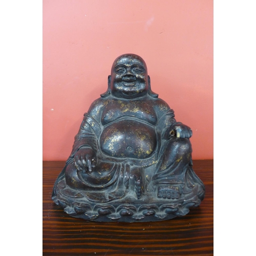 68 - An oriental bronzed seated Buddha