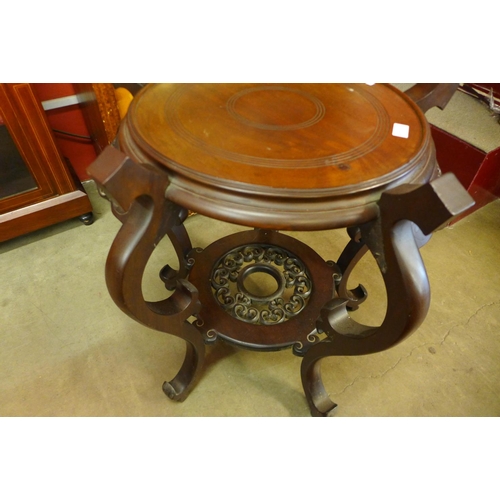 89 - A Chinese carved mahogany circular jardiniere stand