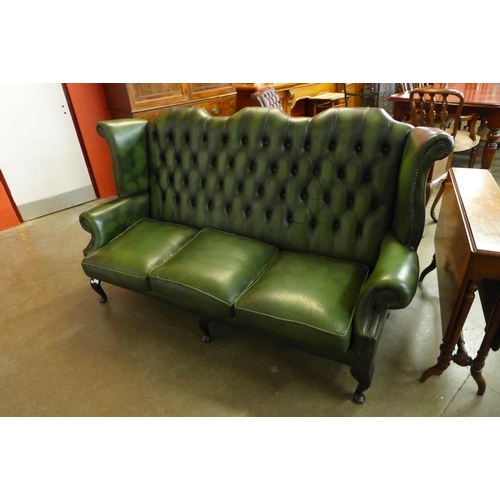 93 - A green leather Chesterfield wingback settee