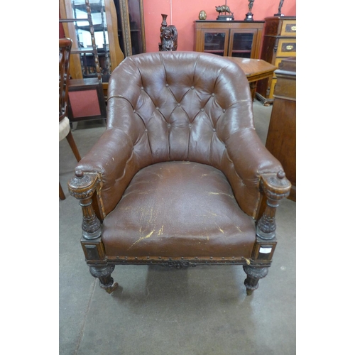 99 - A Victorian carved oak and leather upholstered library armchair