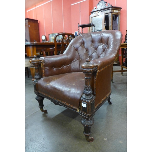 99 - A Victorian carved oak and leather upholstered library armchair