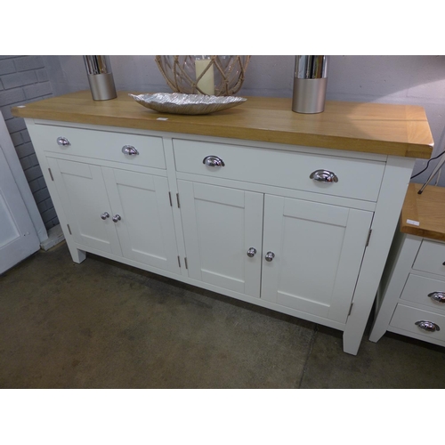 1314 - A cream and oak four door sideboard - this lot is subject to VAT - dents to right hand side