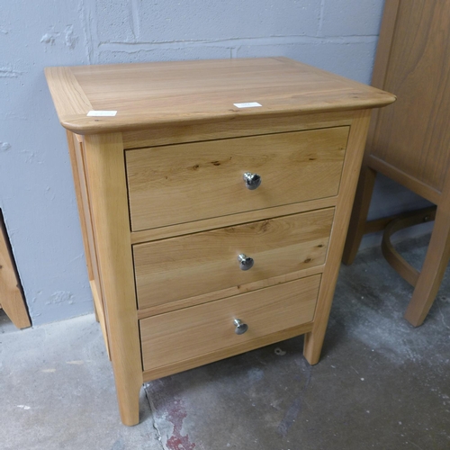 1562 - A large oak three drawer bedside chest   *This lot is subject to VAT