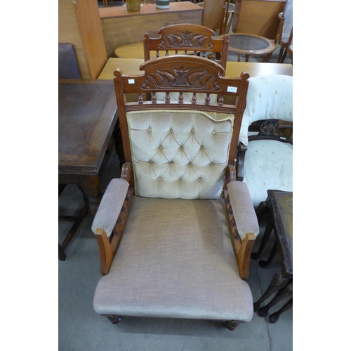 224 - A pair of Victorian carved walnut and upholstered armchairs