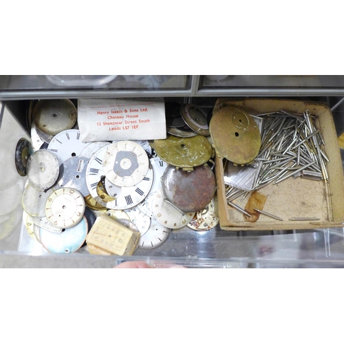 749 - A large collection of watch parts, some tools and clock embellishments