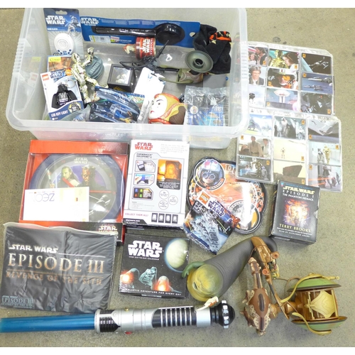 765 - A collection of Star Wars items including a T-shirt, watch, Lego, audio cassettes, collectors cards,... 