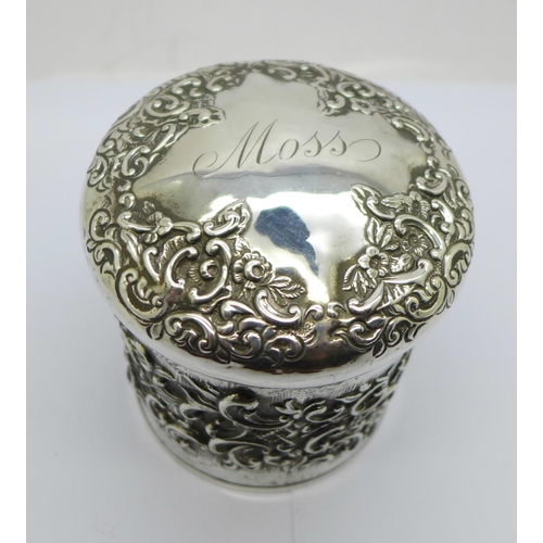 850 - A Victorian embossed silver jar, Birmingham 1897, 137g, the lid bears name, Moss, (some perforations... 