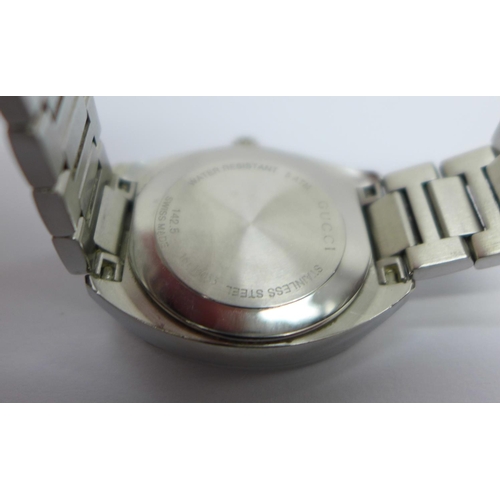 852 - A lady's Gucci stainless steel wristwatch with diamond set markers, with box and booklet