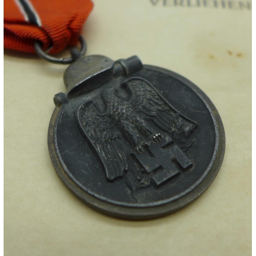 881 - A WWII German Eastern Front medal with paperwork