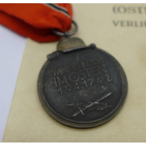 881 - A WWII German Eastern Front medal with paperwork