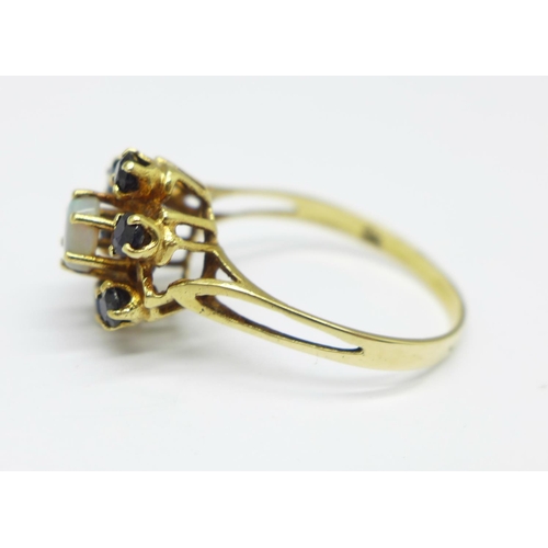 967 - A yellow metal dark sapphire and opal cluster ring, with control marks on the outside of the shank, ... 