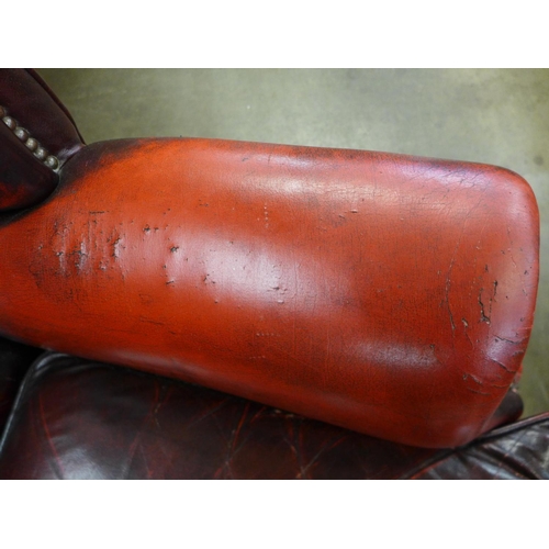 105 - A beech and red leather Chesterfield wingback armchair