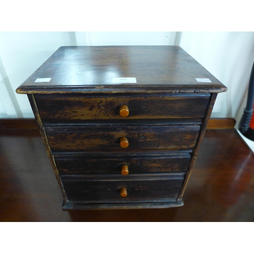 107 - An early 20th Century canary wood table top four drawer chest, made by Henry Stone & Son, 36cms h, 3... 