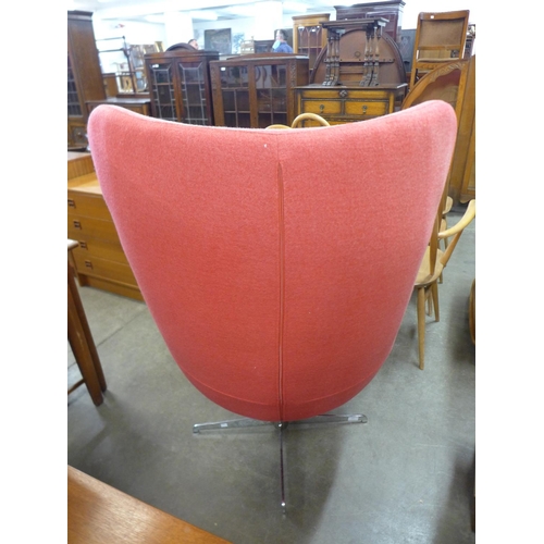 157 - An Arne Jacobsen style chrome and red fabric upholstered egg chair