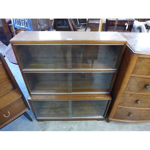 173 - A Minty walnut three tier sectional bookcase