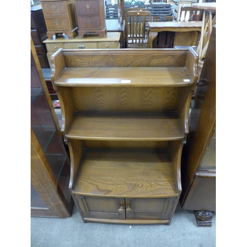 247 - An Ercol Golden Dawn open bookcase