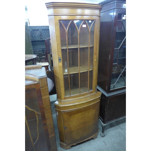 251 - A walnut freestanding corner cabinet