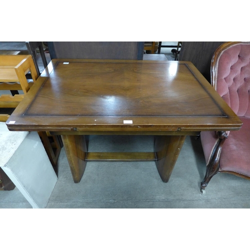 262 - An Art Deco walnut draw-leaf dining table