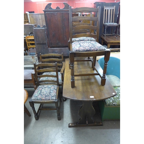 309 - An oak drop-leaf table and four chairs