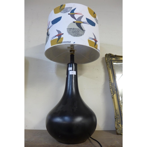 408 - A black ceramic bulbous table lamp