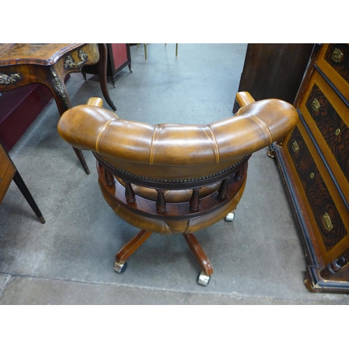 91 - A mahogany and brown leather desk chair